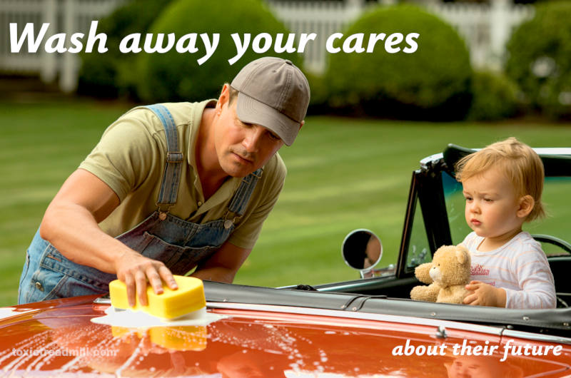 A man washing the bonnet of a shiny red open-top car; a young child hugging a teddy bear sits watching